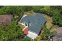 Aerial view of home with fenced backyard, beautiful landscaping, and mature shade trees at 426 Village Dr, Tarpon Springs, FL 34689