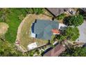 Aerial view of the home, its roof, and the surrounding landscaping and fenced yard at 426 Village Dr, Tarpon Springs, FL 34689