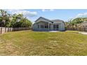 Large backyard with a sprawling lawn and mature trees, offering ample space for outdoor activities at 426 Village Dr, Tarpon Springs, FL 34689