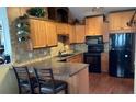 Traditional kitchen featuring wooden cabinets, dark countertops, and modern appliances at 4315 Longshore Dr, Land O Lakes, FL 34639