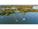 Aerial view of waterfront property with long docks extending into the bay at 450 Bayshore Dr, Terra Ceia, FL 34250