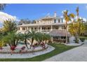 Stunning exterior with spacious porches, a tiki bar, and lush tropical landscaping at 450 Bayshore Dr, Terra Ceia, FL 34250