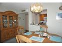 Bright dining area with wooden furniture, stylish lighting, and an open view into the well-equipped kitchen at 4900 Brittany S Dr # 1706, St Petersburg, FL 33715