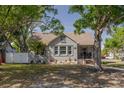 Classic home featuring a cozy front porch, mature trees, and well-maintained landscaping at 505 27Th N Ave, St Petersburg, FL 33704