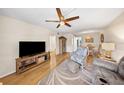Bright living room featuring a ceiling fan, a TV and view of the adjacent dining area at 5080 Locust Ne St # 321, St Petersburg, FL 33703