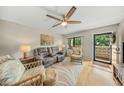 Well-lit living room featuring comfortable seating and access to the balcony at 5080 Locust Ne St # 321, St Petersburg, FL 33703