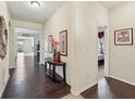 Inviting foyer with dark hardwood flooring, neutral walls, and decorative accents, creating a warm ambiance at 627 Washita Stone Dr, Ruskin, FL 33570
