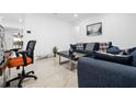 Bright living room boasts shiny tile flooring, modern furniture and decor at 6414 Larmon St, Tampa, FL 33634