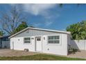 Charming single story home features a well-kept yard, updated windows, and a welcoming front entrance at 7006 N Duncan Ave, Tampa, FL 33604