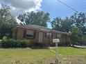 Charming single-story home with a tidy lawn and welcoming front porch at 703 E Hamilton Ave, Tampa, FL 33604