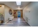 Inviting foyer with wood-look flooring, a skylight, bench seating, and a decorative wall mirror at 9802 Eden Ave, Hudson, FL 34667
