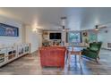 Spacious living room featuring wood-look floors, modern furniture, ceiling fans, and natural light at 9802 Eden Ave, Hudson, FL 34667