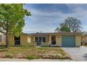Charming single-story home featuring a well-lit exterior and a neatly maintained front yard at 9836 Rainbow Ln, Port Richey, FL 34668