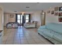 Bright living room featuring tile flooring, neutral walls, and comfortable seating at 9836 Rainbow Ln, Port Richey, FL 34668