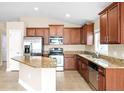 Bright kitchen boasts stainless steel appliances, granite countertops, and lots of cabinets at 10718 Standing Stone Dr, Wimauma, FL 33598
