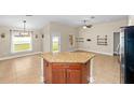 Spacious kitchen island featuring seating and storage, with an open view to the dining area at 10718 Standing Stone Dr, Wimauma, FL 33598