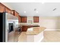 Well-lit kitchen with granite countertops, stainless steel appliances, and ample cabinet space at 10718 Standing Stone Dr, Wimauma, FL 33598