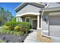 Inviting front entrance with columns, manicured landscaping, and stone accents at 10868 Breaking Rocks Dr, Tampa, FL 33647