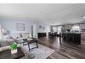 Open-concept living space with wood floors, comfortable seating, and a stylish kitchen island at 11309 Tulane St, New Port Richey, FL 34654