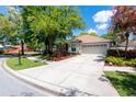 Single-story home with a spacious driveway and well-manicured landscaping creating curb appeal at 11704 Derbyshire Dr, Tampa, FL 33626
