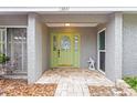 Home exterior featuring a beautiful light green front door with decorative glass inserts and brick walkway at 13841 89Th Ave, Seminole, FL 33776
