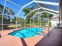 Inviting screened-in pool with a clear blue water, hand rail, and a spacious patio area at 1402 Bluewater Dr, Sun City Center, FL 33573