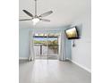 Bright bedroom with a view of the river, ceiling fan, and sliding glass doors to a private balcony at 200 Meres Blvd # 26, Tarpon Springs, FL 34689