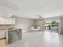 Open living space with a view of the water, tile floors, and built-in shelving for a modern and comfortable setting at 200 Meres Blvd # 26, Tarpon Springs, FL 34689