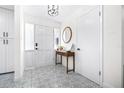 Bright foyer features patterned tile flooring and a decorative table, creating a stylish entrance at 2244 Glenmoor N Rd, Clearwater, FL 33764