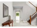 Bright and spacious foyer with marble floors, staircase, and a decorative table at 2935 Winglewood Cir, Lutz, FL 33558