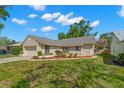 Inviting single-Gathering home with manicured lawn, appealing to potential buyers with its curb appeal at 3261 Pine Forest Dr, Palm Harbor, FL 34684