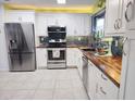 Well-appointed kitchen featuring stainless steel appliances, stylish backsplash, and butcher block countertops at 3339 Avanti Cir, North Port, FL 34287
