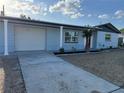 Charming single-story home with a well-maintained lawn, blue paint, a one car garage, and a concrete driveway at 3615 Kingsbury Dr, Holiday, FL 34691