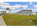 Well-maintained home exterior featuring tidy siding, green lawn, and serene neighborhood setting at 37510 New Horizons Blvd, Zephyrhills, FL 33541