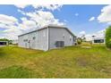 Well-kept home with siding, a lush green lawn, and a side view of the property at 37510 New Horizons Blvd, Zephyrhills, FL 33541