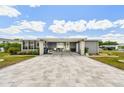 Inviting home with a paved driveway, covered entrance, and well-maintained landscaping at 37510 New Horizons Blvd, Zephyrhills, FL 33541