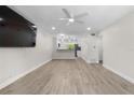 Spacious living room featuring sleek flooring, recessed lighting, and a ceiling fan at 4151 55Th N Way # 1056, Kenneth City, FL 33709