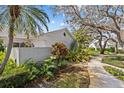 Lush tropical landscaping surrounds this single-story home, accentuating its charming curb appeal at 4208 Edgewood Dr, Holiday, FL 34691