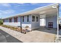 Well-maintained exterior featuring a convenient carport and landscaped front yard at 4851 W Gandy Blvd # B3 L8, Tampa, FL 33611