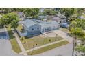 An aerial shot showcasing the home's layout, landscaping, and neighborhood, providing a comprehensive view of the property at 7015 Cobblewood Ct, Tampa, FL 33615