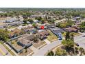 Aerial view of a residential neighborhood featuring a home with a screened-in pool, spacious yard, and mature trees at 7428 Bramblewood Dr, Port Richey, FL 34668