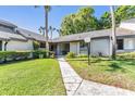 Inviting single-story home featuring a well-manicured lawn and walkway at 90 S Highland Ave # 6, Tarpon Springs, FL 34689