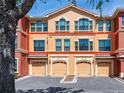 Townhouse exterior showing the red outline of its boundaries and three garage doors at 2709 Via Cipriani # 522B, Clearwater, FL 33764