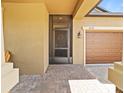 Welcoming front entrance featuring a screened door, brick pathway, and a two-car garage at 10017 Victory Gallop Loop, Ruskin, FL 33573