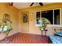 Inviting covered porch with tiled flooring and decorative front door at 10601 42Nd N Ct, Clearwater, FL 33762
