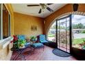 Cozy front porch with tiled floor, seating, and decorative iron gate at 10601 42Nd N Ct, Clearwater, FL 33762