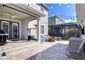 Outdoor patio with brick pavers, a cozy seating area, a grill, and a ceiling fan for outdoor comfort and enjoyment at 11309 Grand Park Ave, Riverview, FL 33578