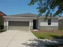 Charming single-story home featuring a two-car garage and a well-maintained front yard at 11527 Southern Creek Dr, Gibsonton, FL 33534