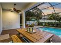 Relaxing screened-in pool area with dining and seating areas, perfect for entertaining at 13008 Eagles Entry Dr, Odessa, FL 33556