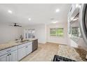 Bright kitchen featuring stainless steel appliances, tile floors and a window for natural light at 1308 W Perdiz St, Tampa, FL 33612